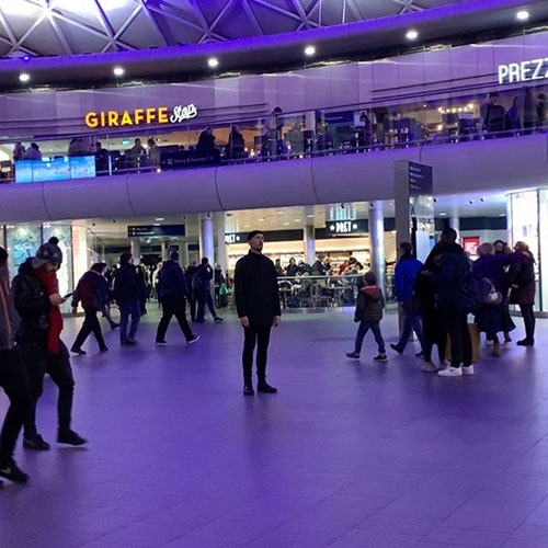 the performer is surrounded by travellers